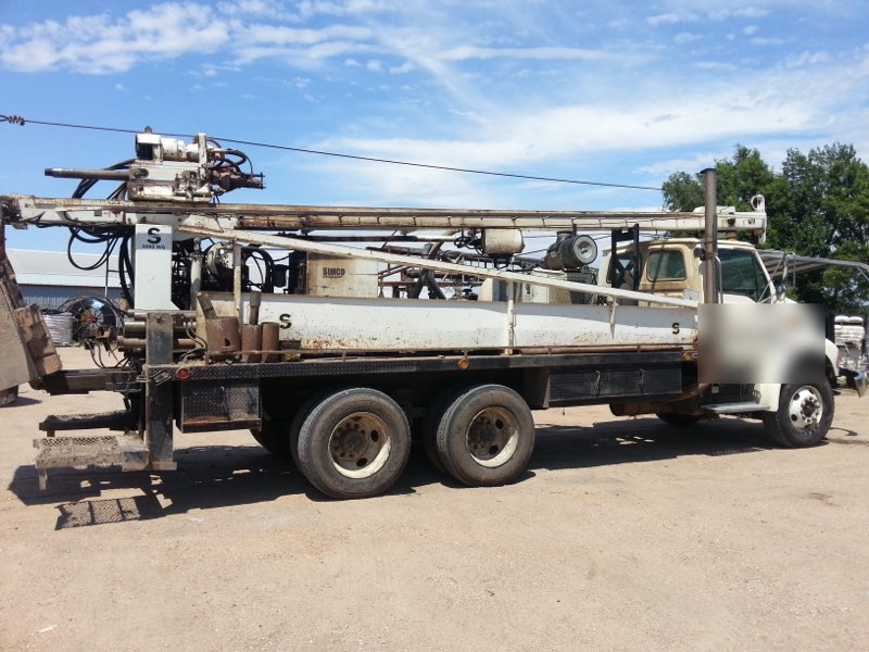 A water well drilling rig set up at a job site